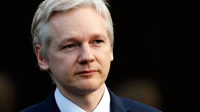 Zdjęcie przedstawia Juliana Assange, mężczyznę, ubranego w garnitur, ma siwe włosy
